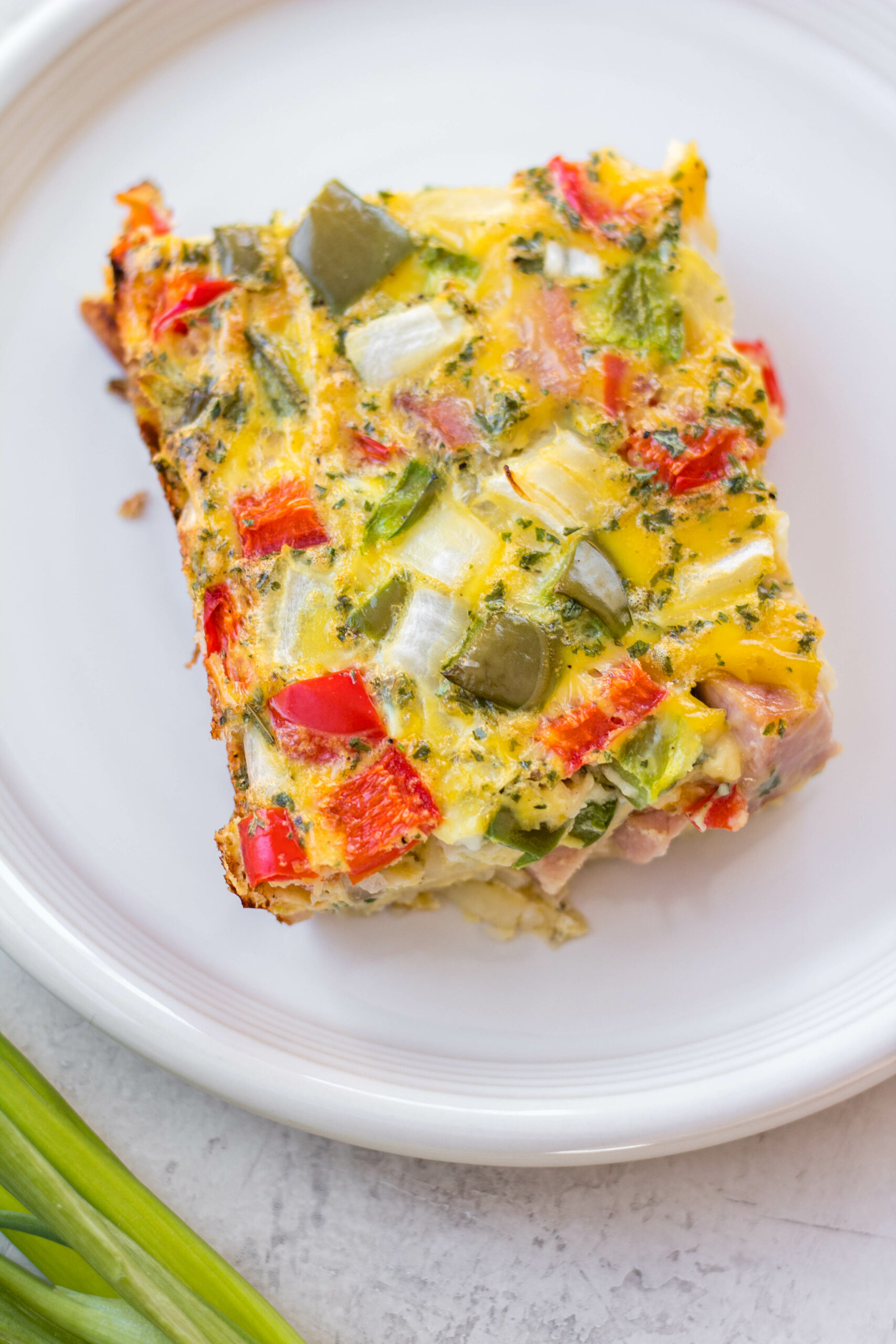 A ham egg bake is the perfect use for any leftover ham you might have on hand. It makes enough to feed a gathering or for an easy breakfast prep for the days ahead. This recipe is gluten free and is simple to make with easy ingredients. The ham and peppers flavors are a classic the everyone loves and can be customized to make it perfect for your crew. #leftoverhamrecipes #hamrecipes #eggbake #healthybreakfastrecipes #hamandpeppers